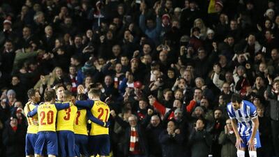 Arsenal players celebrate after one of their goals in a 3-2 win over Brighton in the FA Cup on Sunday. Stefan Wermuth / Reuters / January 25, 2015