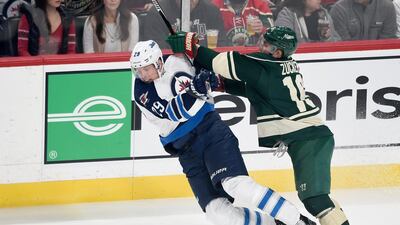 Jason Zucker of the Minnesota Wild knocks Patrik Laine of the Winnipeg Jets to the ice on October 15, 2016 n St Paul, Minnesota. Hannah Foslien / Getty Images