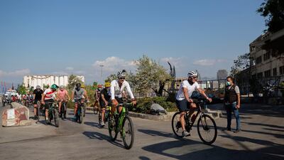 Former American professional cyclist Lance Armstrong, right, rides with Lebanese and foreign cyclists at the site of the August 4 deadly blast in the port of Beirut that killed scores and wounded thousands in Beirut. AP