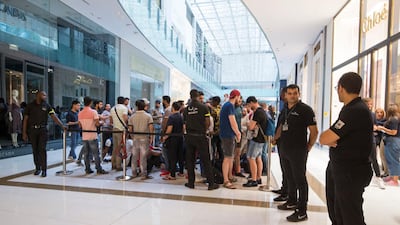 Customers in Dubai Mall queued through the night to be one of the first to get their hands on Apple's new iPhones. Leslie Pableo / The National