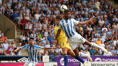 Chelsea's Spanish defender Marcos Alonso, centre, vies with Huddersfield Town's Beninese striker Steve Mounie. AFP