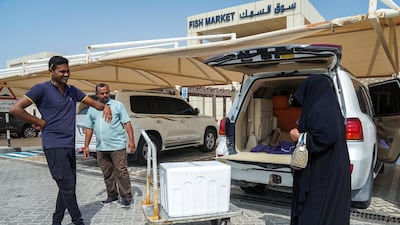 A customer prepares to stock up on tasty treats from Mirfa Fish Market.