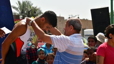 Faris Al Zaabi receives his medal at the Luxor ATU Sprint Duathlon African Championships and Pan Arab Championships. Courtesy UAE Triathlon Association