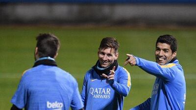 Lionel Messi and Luis Suarez of Barcelona chat with Gerard Pique during training on Monday for the Club World Cup. Franck Robichon / EPA
