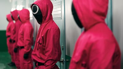 In the show, debt-laden contestants vie for a prize of 45.6 billion won ($38.40 million) by competing in games that recall a more idyllic pre-digital time, overseen by masked enforcers. Photo: Netflix