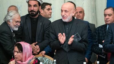 Former Afghan president Hamid Karzai applauds during talks with the Taliban in Moscow. AP