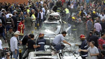 Lebanese civil defence personnel extinguish cars on fire at the site of explosions near the Iranian embassy in Beirut. Mahmoud Kheir / Reuters