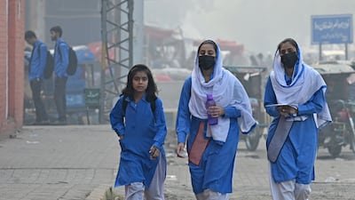 Students on a street in smoggy conditions in Lahore this week. AFP