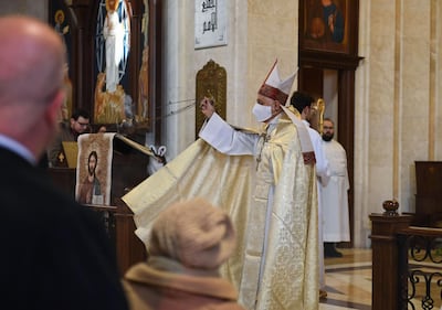 A priest of the Chaldean Church leads the Christmas morning mass at a church in Aleppo. Many will hope, yet again, that a new year brings better news for the country. AFP