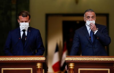 French President Emmanuel Macron and Iraqi Prime Minister Mustafa Al Kadhimi react during a news conference after a meeting, in Baghdad, Iraq on September 2, 2020. Reuters