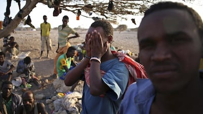 A man from Ethiopia covers his face as he waits with other illegal immigrants for a boat to cross into Yemen outside the town of Obock, in north Djibouti. Goran Tomasevic / Reuters / February 22, 2015