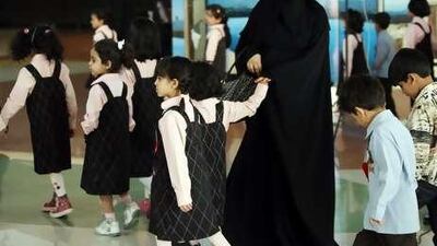 A Saudi teacher leads students as they visit a shopping mall in Riyadh.