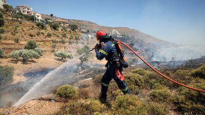 A firefighter works to extinguish a wildfire in Keratea, near Athens, in June. Reuters
