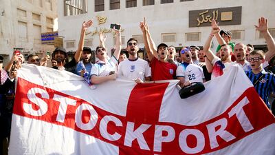 England fans with a Stockport County flag, in the Souq area of Doha. PA