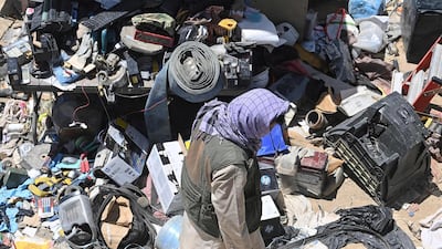 A man selects valuable items at a recycling workshop near the Bagram Air Base. AFP