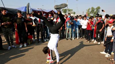 A demonstrator performs a handstand in Najaf. Reuters
