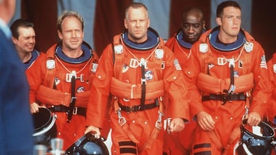 Bruce Willis, Ben Affleck, Will Patton, Steve Buscemi and Michael Clarke Duncan sport Nasa's 'pumpkin' suits in the 1998 space adventure Armageddon. Getty Images / Touchstone Pictures