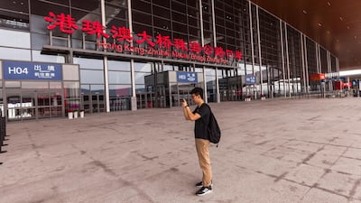 A man takes pictures outside the Zhuhai station.