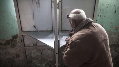 An Egyptian man casts his vote on a new constitution in the Al Haram neighbourhood in the southern Cairo. Mahmoud Khaled / AFP Photo