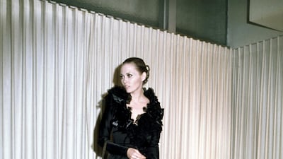 1968: Faye Dunaway arrives at the 1968 Oscars in a black feathered gown. Bettmann