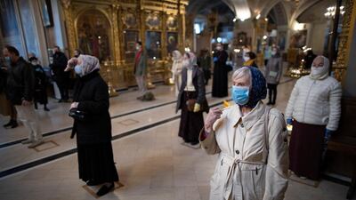 Parishioners wearing face masks to protect against the coronavirus, observe social-distancing guidelines cross themselves as they attend service at the Epiphany Cathedral in Moscow. Churches in the Russian capital reopen after a two-month lockdown imposed to control the spread of the virus. AP Photo