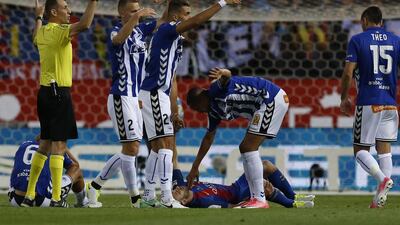 The referee and Alaves players call for medical assistance for Barcelona’s Javier Mascherano who got injured and had to be carried off on a stretcher. Francisco Seco / AP Photo