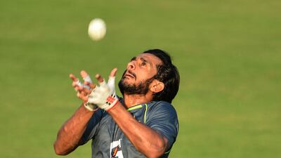 Pakistan's Hasan Ali catches a ball during a practice session at the Rawalpindi Cricket Stadium in Rawalpindi on September 14, 2021, ahead of their first one-day international (ODI) cricket match against New Zealand. (Photo by Farooq NAEEM / AFP)