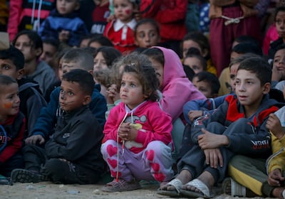 Displaced Palestinian children watch a film at an open-air cinema in Gaza city. EPA