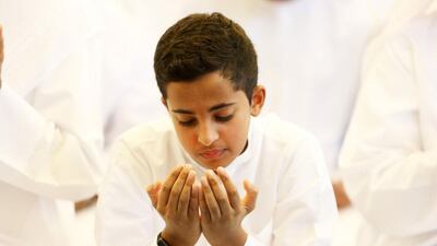 A boy prays at Zabeel Mosque in Dubai. Pawan Singh / The National