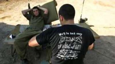 Israeli soldiers rest on the border with the Gaza strip yesterday.