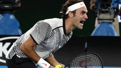Roger Federer celebrates after winning the Australian Open. Kin Cheung / AP Photo