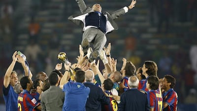 Barcelona players throw coach Pep Guardiola in the air after defeating Estudiantes in the Club World Cup final in Abu Dhabi. Fahad Shadeed / Reuters