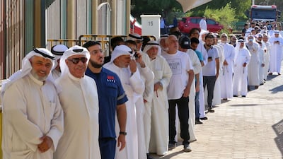 Kuwaitis queue up outside a polling station to vote during parliamentary elections in Kuwait City. Kuwait is holding its most inclusive elections in a decade, with some opposition groups ending a boycott after the country's royal rulers pledged not to interfere with Parliament. AFP