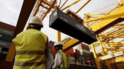 Two employees of DP World supervise uploading the containers at the Jebel Ali port terminal 1 in Dubai.