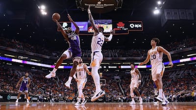 Harrison Barnes of the Sacramento Kings attempts a shot over Phoenix Suns' Deandre Ayton during the second half of the NBA game at Talking Stick Resort Arena in Arizona on October 23, 2019.