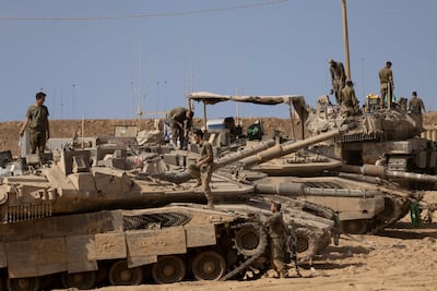 Israeli soldiers and their tanks near the border with the Gaza Strip. Getty Images