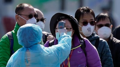 A worker in protective gear checks a passenger after she disembarked the Diamond Princess cruise ship at the Daikoku Pier Cruise Terminal in Yokohama, south of Tokyo, Japan, 21 February 2020. Passengers have been disembarking since 19 February following a two-week-long quarantine period after around 600 passengers and crew were infected with the novel coronavirus. The SARS-CoV-2 outbreak, which originated in the Chinese city of Wuhan, has so far killed more than 2,000 people with over 76,000 infected worldwide, mostly in China. EPA