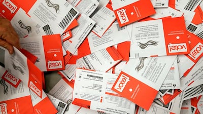 Election workers begin to sort a new batch of ballots collected earlier in the day from drop boxes at the King County Elections office in Renton, Washington. Voters in Washington all vote only by mail. AP