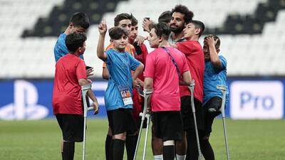 Disabled children join Liverpool's Mohamed Salah during a training session of Liverpool FC in Istanbul, Turkey. EPA