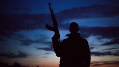 A 21-year old from the UK, nick-named by Kurdish fighters as Hewal Givara, stands with his weapon at night in the outskirts of the north-western Syrian town of Tal Tamr, north of Hasakeh, near the border with Turkey, as he fights alongside People Protection Unit (YPG) fighters under the commanders, Sider and Gerzan.