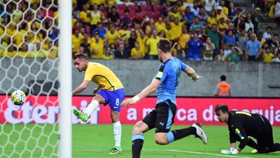 Brazil’s Renato Augusto (L) scores against Uruguay during their Russia 2018 Fifa World Cup South American Qualifiers’ football match, in Recife, northeastern Brazil, on March 25, 2016. AFP PHOTO / CHRISTOPHE SIMON