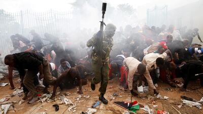People fall as police fire tear gas to try control a crowd trying to force their way into a stadium to attend the inauguration of president Uhuru Kenyatta at Kasarani Stadium in Nairobi, Kenya on November 28, 2017. Baz Ratner / Reuters