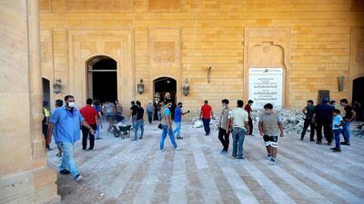 People clean debris at Mohammed Al Amin mosque in the centre of Beirut. AFP