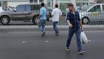 Despite the threat of a Dh200 fine, pedestrians continue to use a gap in the median fence near Abu Dhabi’s Lifeline Hospital to cross the street, often dodging vehicles on Muroor Road, as they wait for a break in the traffic. Delores Johnson / The National