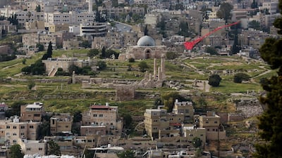 A picture taken on April 27, 2020, shows a kite flying over the Jordanian capital Amman, with the Amman Citadel in the background. AFP