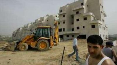 Arab workers construct new housing units for Jewish settlers in the West Bank settlement of Givat Zeev in March of this year.