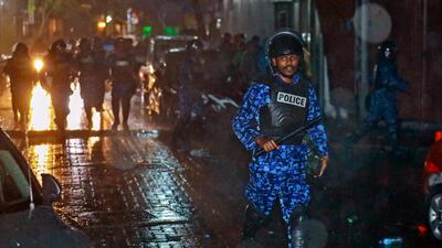 A Maldives policeman charges with a baton towards protesters after the government declared a 15-day state of emergency in Male, Maldives, on Tuesday, February 6, 2018. Mohamed Sharuhaan / AP