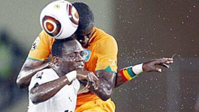 Ivory Coast's Yaya Toure, right, wins the aerial duel for the ball from Ghana's Emmanuel Agyemang-Badu in Cabinda.