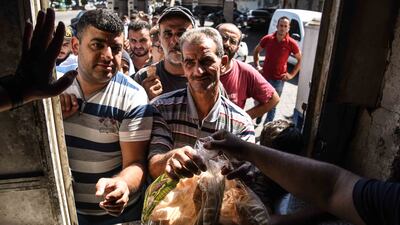 People queue for bread as shortages continue. Elizabeth Fitt for The National