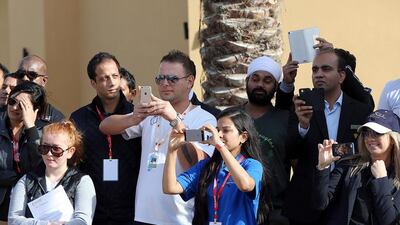 Supporters take photos of colleagues during the event.